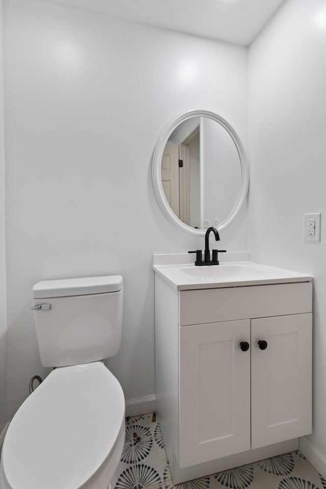 bathroom with tile patterned floors, vanity, and toilet