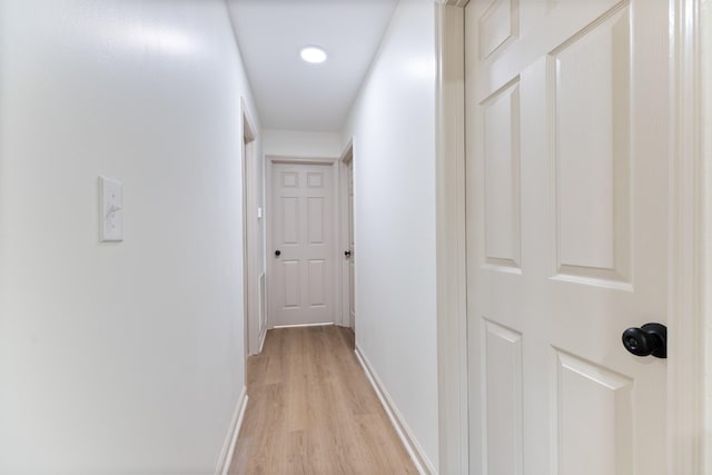 hallway with light hardwood / wood-style floors