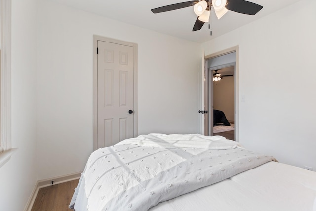 bedroom featuring hardwood / wood-style flooring and ceiling fan