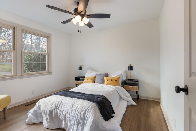 bedroom with ceiling fan and wood-type flooring