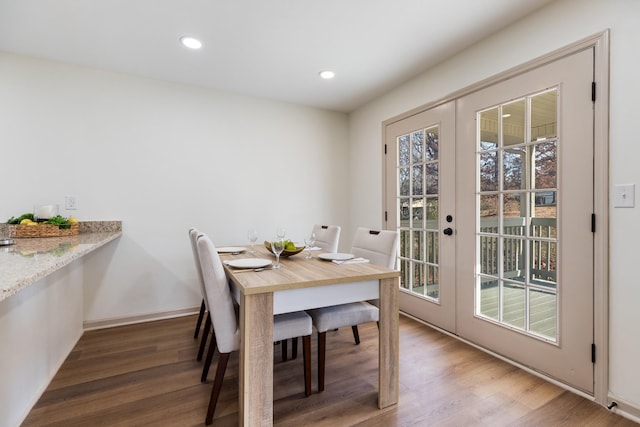 dining room with hardwood / wood-style flooring and french doors