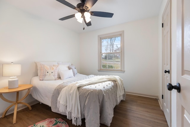 bedroom with dark hardwood / wood-style flooring and ceiling fan