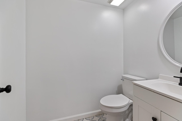 bathroom featuring tile patterned flooring, vanity, and toilet