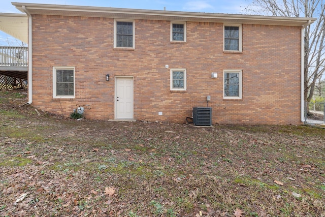 rear view of house with central AC unit and a deck