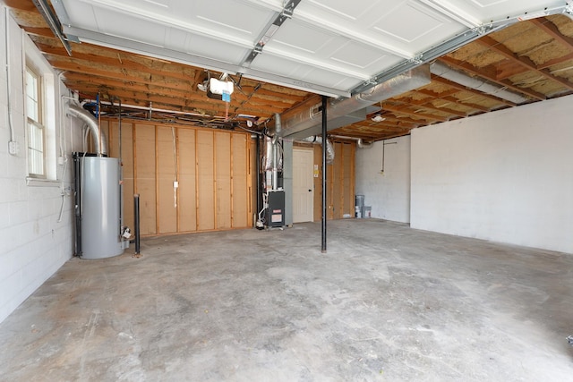 garage featuring heating unit, a garage door opener, and water heater