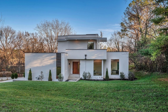 contemporary home featuring a front lawn