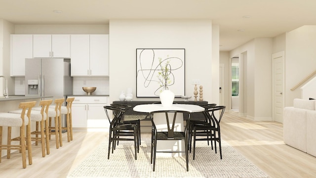 dining space featuring light wood-type flooring