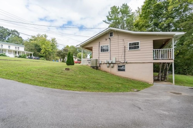 view of property exterior featuring a yard and central AC