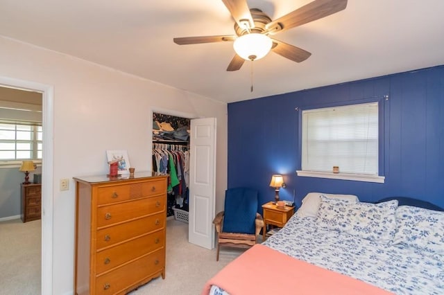 carpeted bedroom featuring ceiling fan and a closet