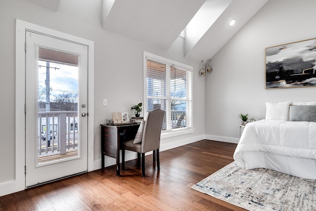 bedroom with lofted ceiling with skylight, dark wood-type flooring, access to outside, and multiple windows