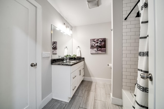 bathroom featuring shower / tub combo and vanity