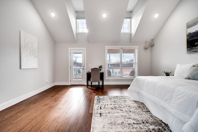 bedroom featuring multiple windows, dark hardwood / wood-style floors, and access to exterior