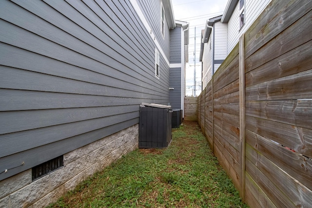 view of side of property featuring central air condition unit