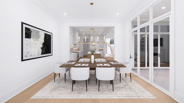 dining room featuring hardwood / wood-style flooring, crown molding, french doors, and a notable chandelier