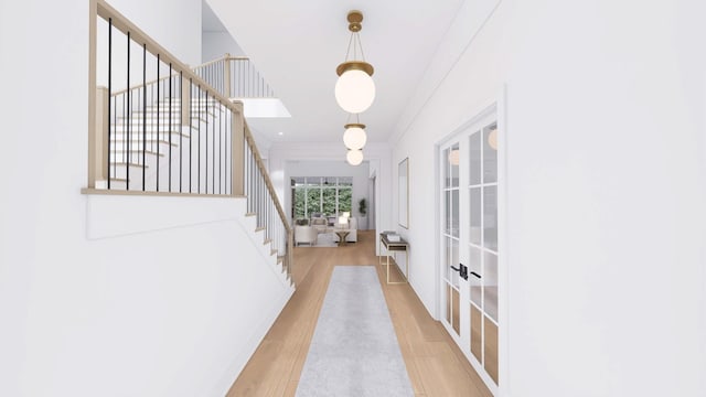 corridor featuring light hardwood / wood-style floors and french doors