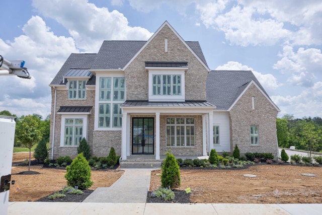 6072 Porters Union Way, Arrington, TN 37014 - craftsman inspired home with covered porch, roof with shingles, a standing seam roof, and brick siding