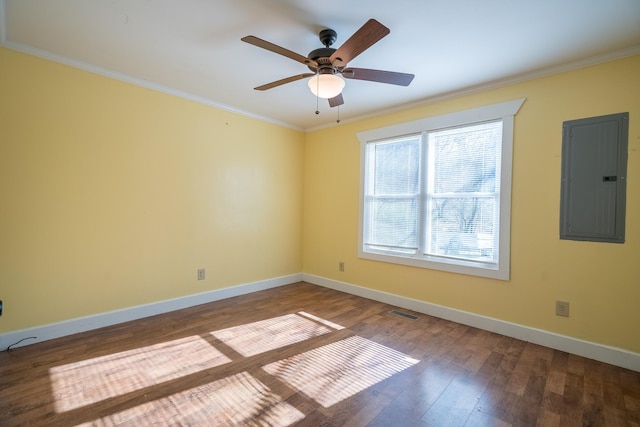 spare room featuring wood-type flooring, ceiling fan, electric panel, and crown molding