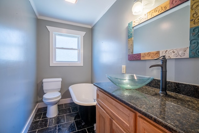 bathroom featuring crown molding, a bathing tub, vanity, and toilet