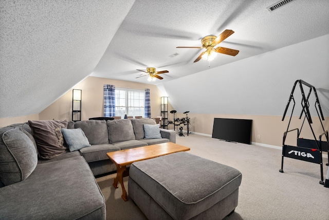 living room featuring carpet flooring, ceiling fan, lofted ceiling, and a textured ceiling