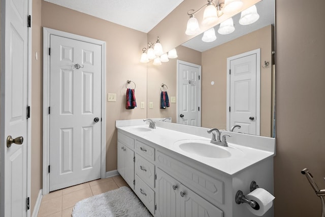 bathroom featuring tile patterned flooring, vanity, and a textured ceiling