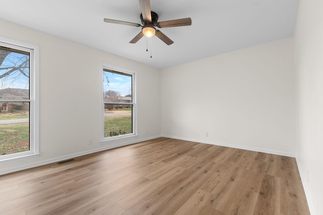 spare room with ceiling fan and light hardwood / wood-style floors