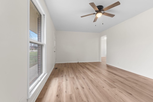 empty room with ceiling fan and light hardwood / wood-style floors