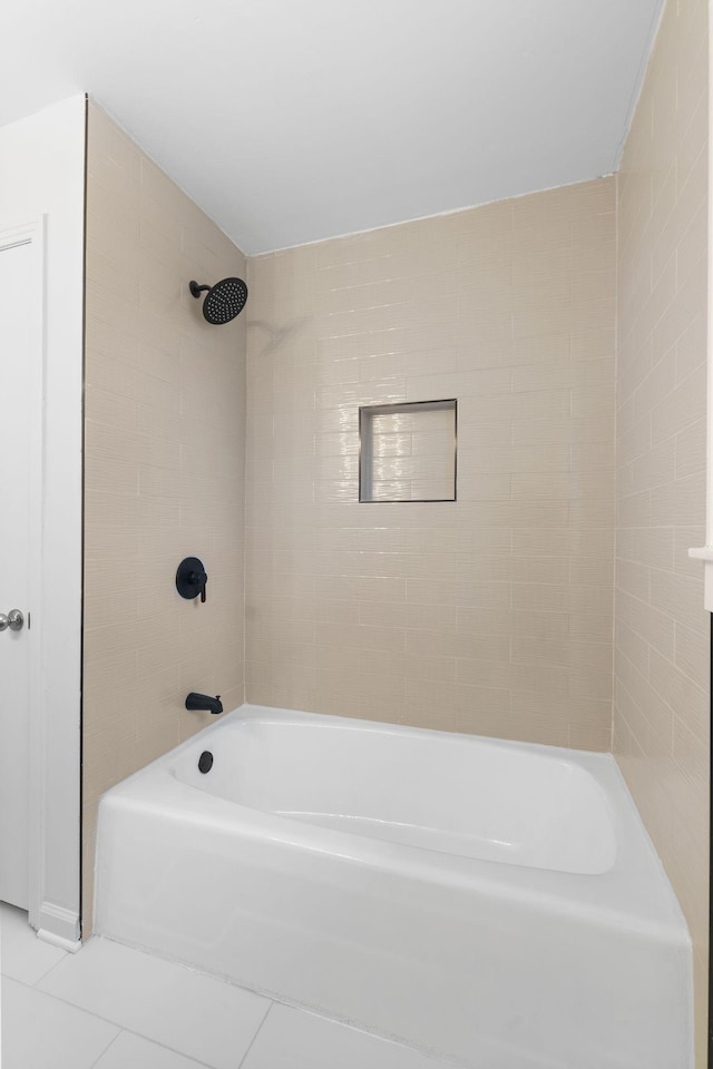 bathroom with tiled shower / bath combo and tile patterned floors