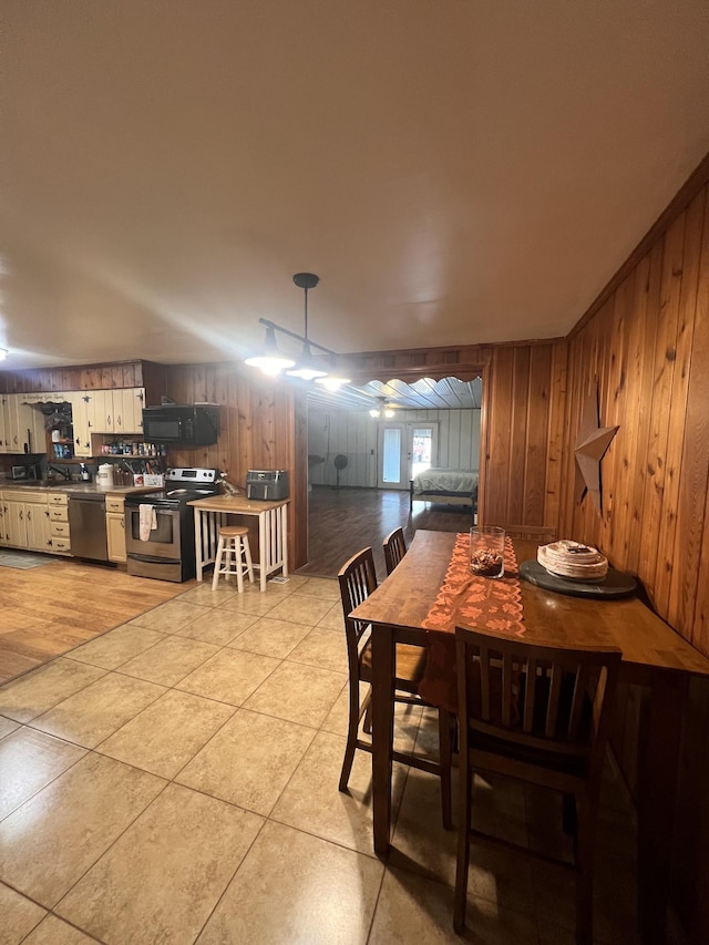 tiled dining room with wood walls