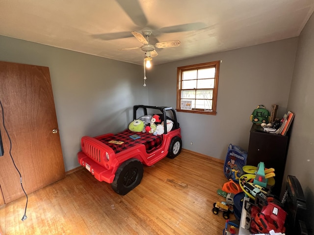 bedroom featuring hardwood / wood-style flooring and ceiling fan