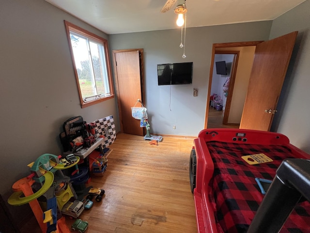 bedroom featuring light wood-type flooring and ceiling fan