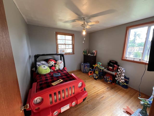 bedroom featuring ceiling fan and light hardwood / wood-style floors