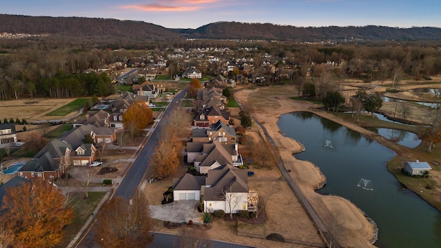 aerial view at dusk with a water view