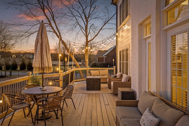 deck at dusk featuring an outdoor living space