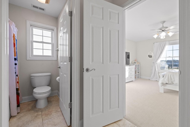 bathroom featuring toilet, ceiling fan, and tile patterned floors