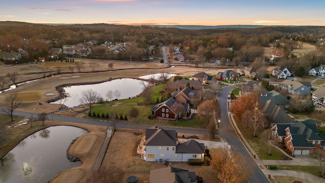 aerial view at dusk with a water view