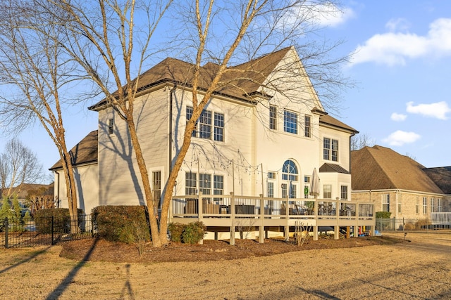 rear view of property with a wooden deck