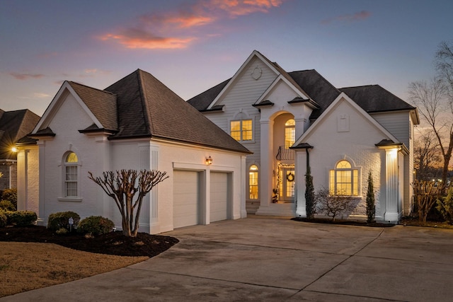 french country home featuring a garage