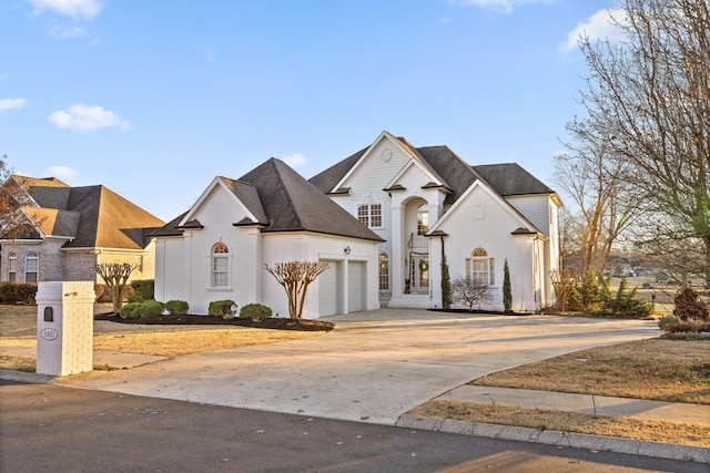 french country inspired facade featuring a garage