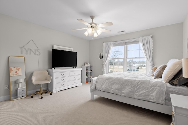 bedroom featuring ceiling fan and light carpet