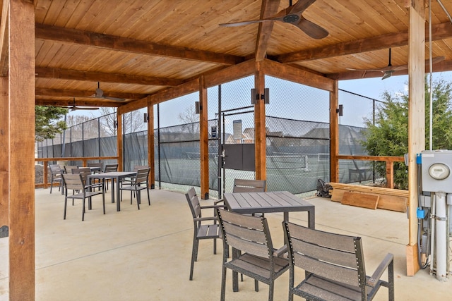 view of patio with ceiling fan and tennis court