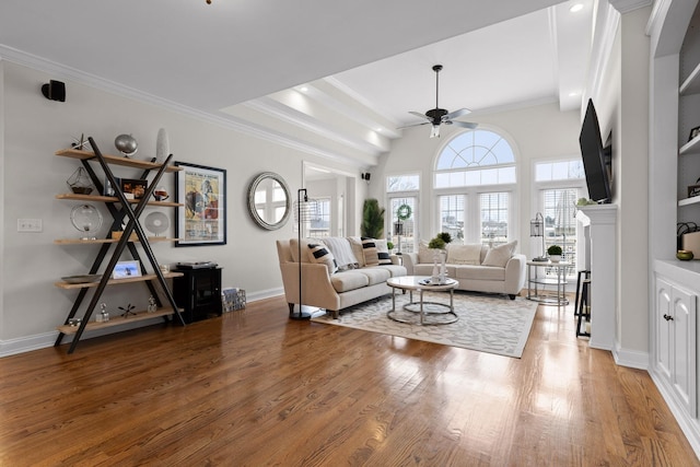 living room featuring wood-type flooring, ceiling fan, and crown molding