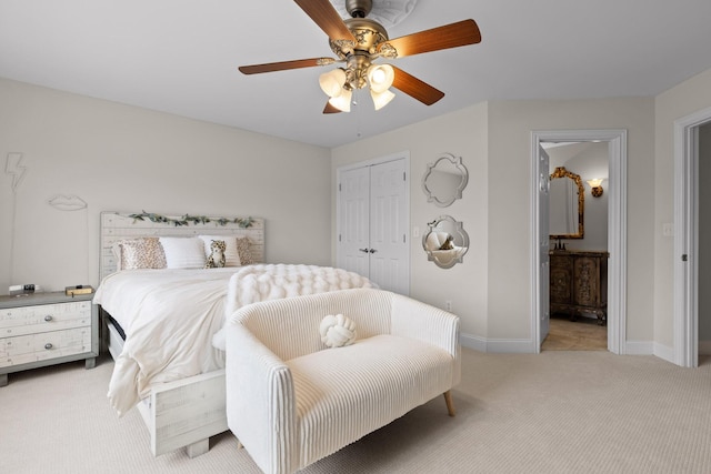 bedroom with light colored carpet, a closet, ceiling fan, and ensuite bathroom