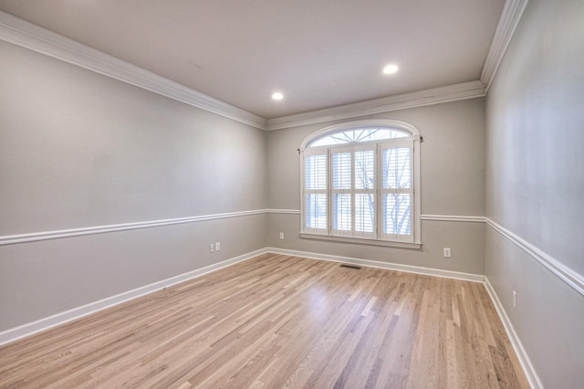 spare room with light hardwood / wood-style floors and ornamental molding