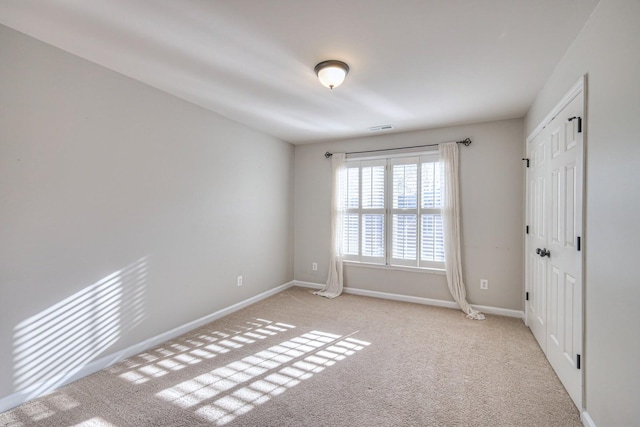 empty room with light colored carpet