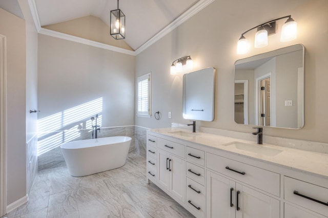 bathroom featuring vanity, ornamental molding, a tub to relax in, and vaulted ceiling