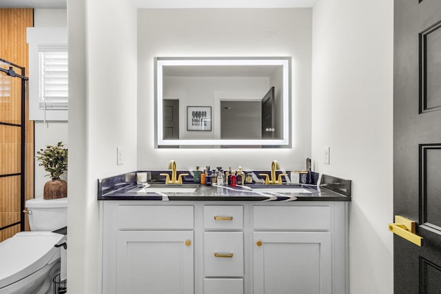 bathroom featuring vanity and toilet