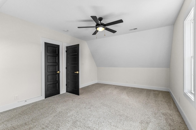 additional living space featuring carpet floors, ceiling fan, and lofted ceiling