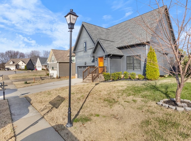 view of front property with a garage and a front yard