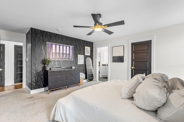 bedroom featuring carpet, ceiling fan, and ensuite bathroom