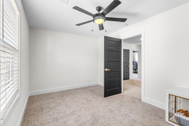 unfurnished bedroom with light colored carpet and ceiling fan